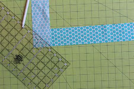 Place two 2-1/2 fabric strips right sides together and at a 90