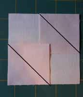 Press the corners from left to right(or right to left) so that one corner is pressed towards the centre and the other