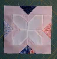 Sew the shorter sides on opposite sides of the cross block FIRST, then after checking placement on the design wall, sew the correct long strips to