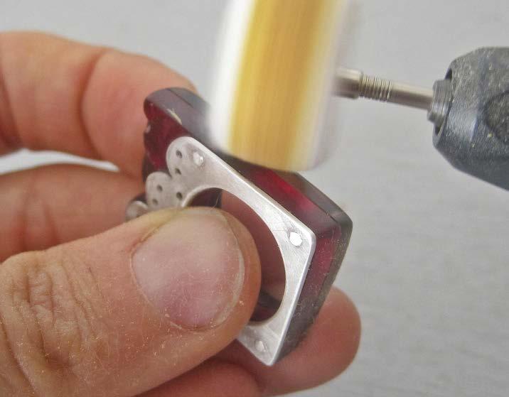 File the straight outside edges and interior edges of the ring with a coarse half-round file. After you remove the excess material, use a fine needle file to get rid of all the coarse file marks.