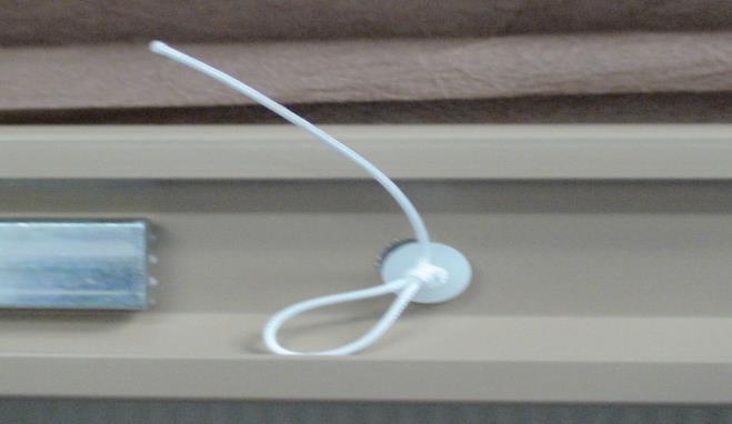 Thread cord through hole of cinch button as shown.