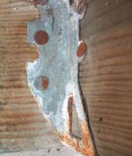 Good news for the environment is bad news for decks. New wood preservatives cause accelerated corrosion. Galvanized joist hanger attached to ACQ wood, 7 months; wet conditions.