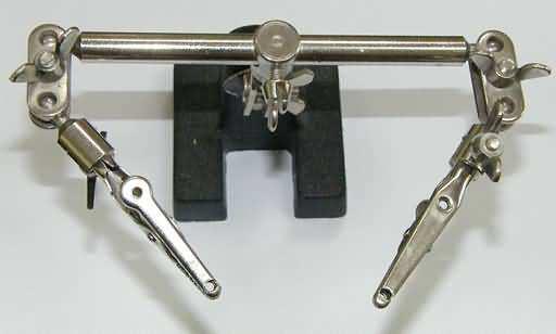 Third Hand Apparatus Another tool that is very handy to have, but not a necessity, is a "third hand" apparatus of some kind. A commercial version is shown in figure 4.