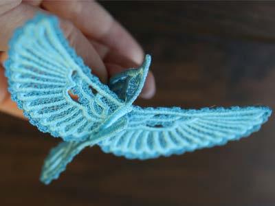 Insert the wings into the slot on the back of the bird, making sure the right side of the lace wings is