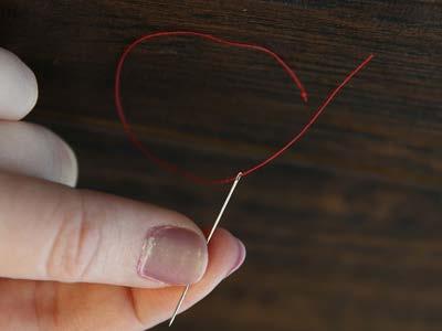 First, cut a piece of thread that is 6" long, and tie a knot at one end.