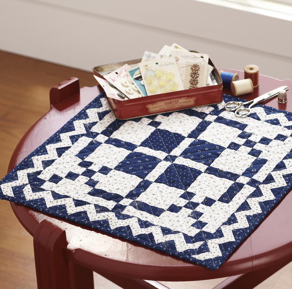DESIGNER ANN HERMES (ANNHERMESQUILTS.COM) A two-color mini quilt makes a stunning table topper.