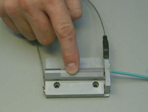 2 Apply the tape to the tray, covering the fibers and securing