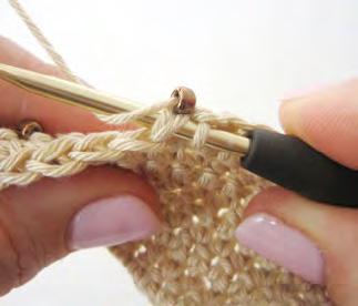 is required. Step 2: Slide the bead along the yarn until it sits as close to the hook as possible.