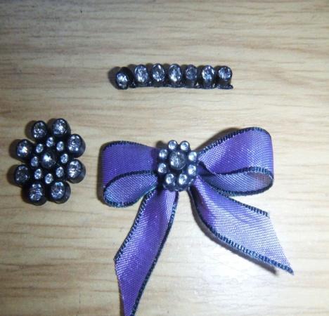 Step 19. Make a single bow using the purple shimmer ribbon.
