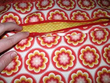 If you have made a hidden zipper pocket before go ahead and add it into your lining placing it 2" down from your added jelly roll strip and centering it from side to