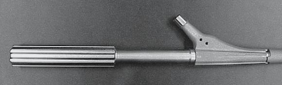 The threaded rod with T-handle is screwed into the disassembly instrument (a) which is positioned over the threaded sleeve (c).