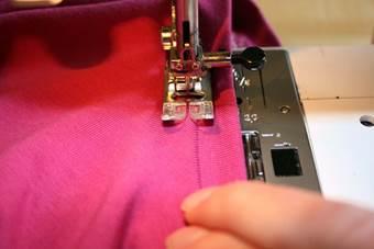 9. At the neckline topstich with a straight stitch. Lower tension of the upper thread and use a large stitch, stretch neckline while sewing or use an elastic stitch.