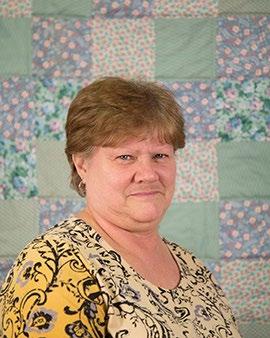 Her background quilt is one of two quilts that is hand quilted. Pam W.