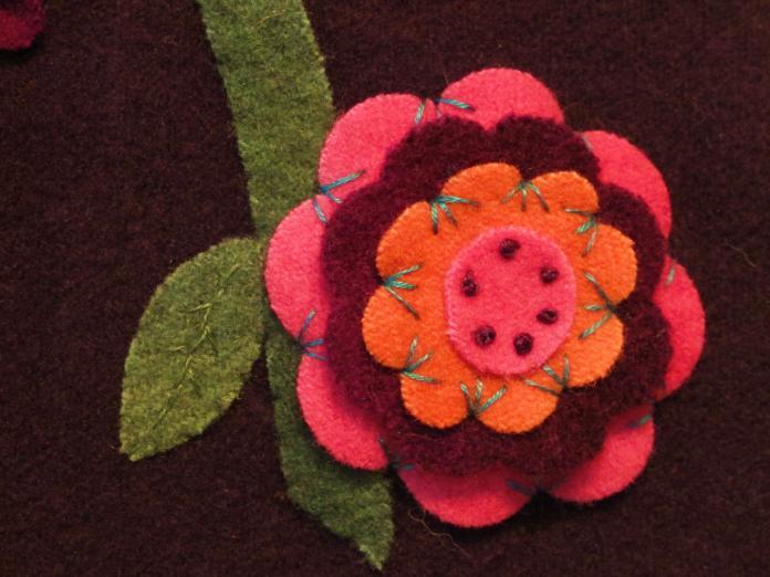 Use three strands of floss to stitch six French knots around the circle, taking care to go through