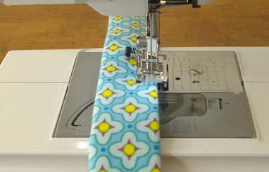 Take the two folded and ironed straps and sew 1/4 seam allowance along both