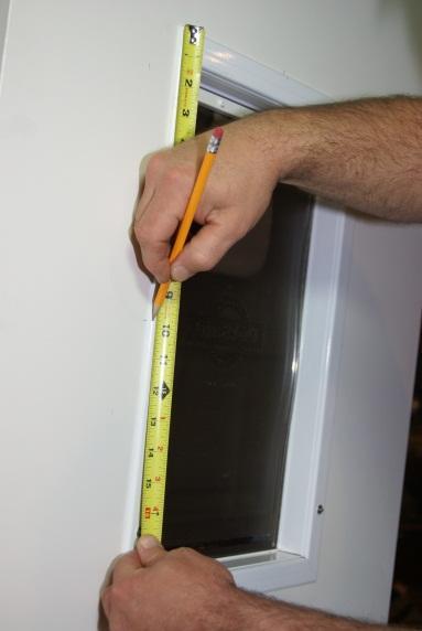 4) NOW MARK THE CENTER LINE OF THE SIDE OF THE EXISTING PET DOOR THESE LINES WILL ALSO BE LINED UP LATER TO CENTER YOUR NEW DOOR.