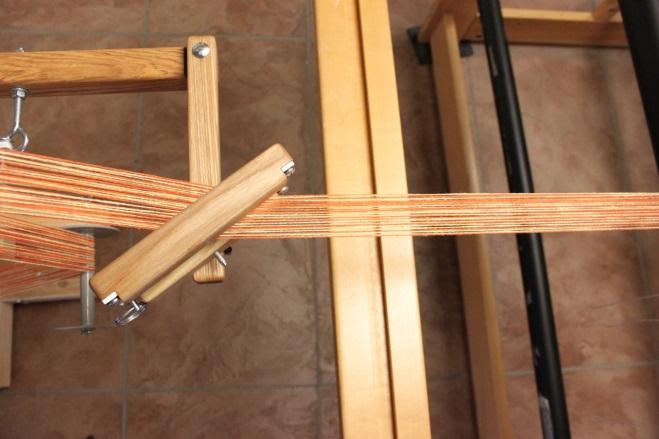 Warping the Sectional Beam masking tape. This will help you keep the threads in order when you thread the harness.