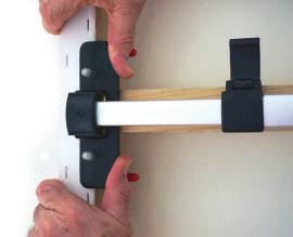 right hand, grip T-Bar end and the canvas frame together so that it does not fall