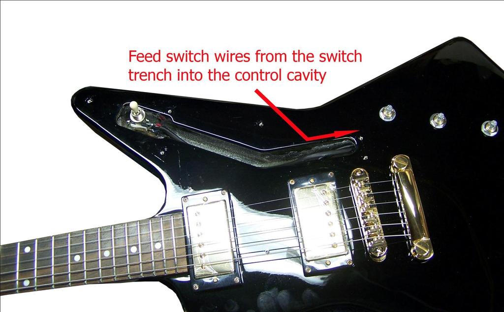 Step 16. Feed the wires of the new switch harness from the switch trench into the control cavity and then position the switch where it should sit once the pick guard has been attached (see fig. 7).