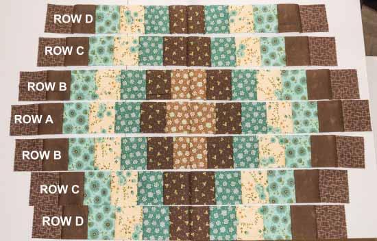 Row A: join two strips, making sure center squares are of the same fabric. Add one 2-1/2" x 2" rectangle of background fabric to each end, and press new seams.