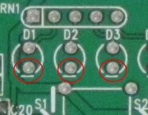These are near the top on the left. This component has a special orientation: Make sure the short wire goes into the hole with the text Dn (e.g. D1, D2) next to it.