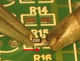 The bottom one (R15) as a small additional amount of solder on the right hand side to form a slight dome. Use tweezers to pick up the resistor.