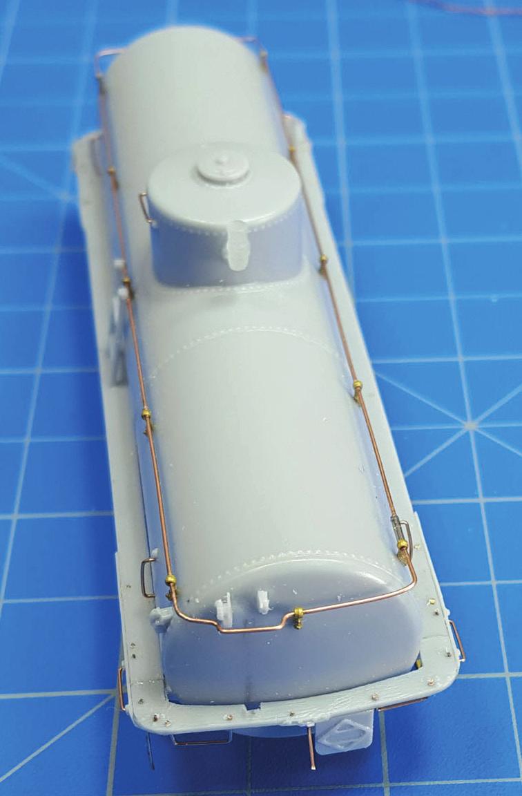 Drill out the holes for the running board supports along the bottom of the upper tank side with a #53 drill (Photo 17).