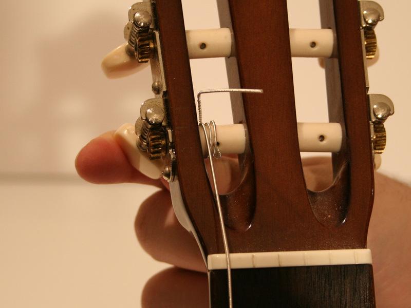 As you tighten the string, be sure to hold the string with your free hand until the string