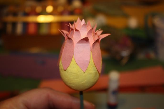 Glue the petals so that their points are about even with the folds of the first row.