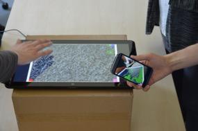 Figure 1. The game was developed to be played on a large multi-touch tablet and multiple smartphones.