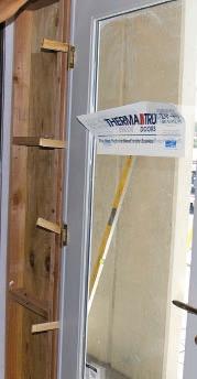 Installing French Doors Figure 6. Shims are critical for door performance. They re needed behind every hinge (left) and across the top jamb.