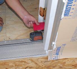 Shims are needed behind all the hinges and across the top of the unit to prevent the heavy glazed doors from twisting the jambs as they swing.
