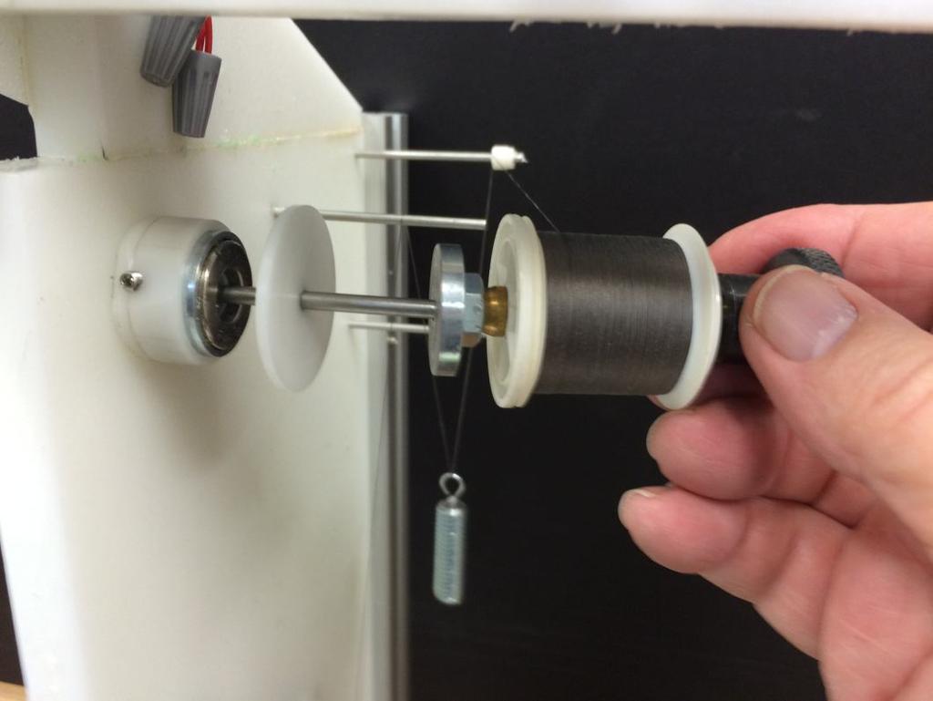 Thread spools are mounted on a spindle and secured with the steel thumb