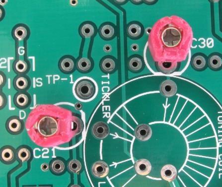 Bottom Side Components Add C21 and C30, the two pink trimmer capacitors. These mount on the bottom side of the board, soldered on the top side. Notice the case has a flat side.