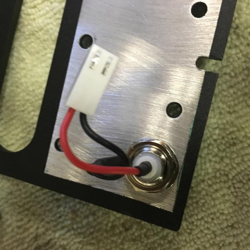 With the factory end panel now free, using a sharp pointed Awl or Pen Knife tip depress the metal contact in the white connector housing from the BNC for just the RED wire.