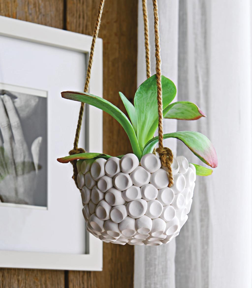 A PRESS TO IMPRESS Balls of white polymer clay dot the surface of a mod hanging planter, below. To make a form, cover an upside-down, oven-safe flowerpot with parchment paper.
