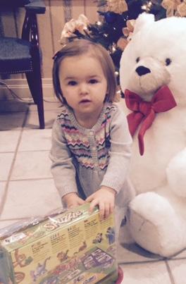 Bella, age 5, a winner of the Giant Plush Teddy Bear and wagon of toys at the Oceanside Branch 5.