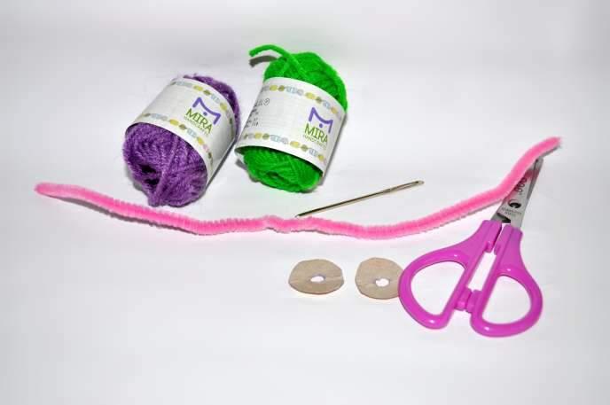 Materials: - Scissors - yarn - needle - 2 carboard holed disks - 1 pipe cleaner 5 Yarn Grape