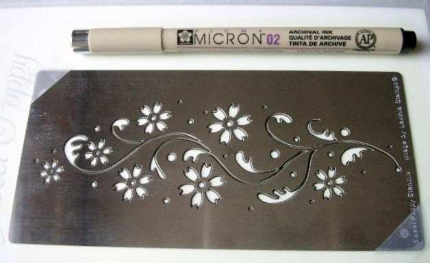 Step 1: Secure stencil on top of a piece of parchment craft paper, using a Pigma micron pen size 02
