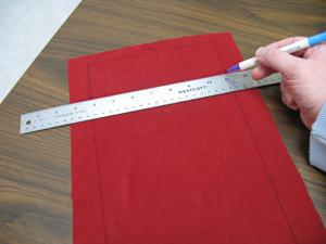 Next, using an air-erase pen (or other marking tool), measure and mark 2 1/2 inches down from each top corner along the sides. Draw a line to connect these marks.