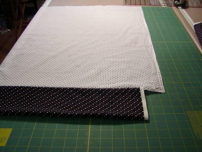 Fold the pillowcase in half lengthwise with WRONG sides together and trim off any excess fabric and selvages along the side,