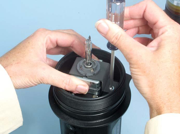 Use a magnetic Phillips screwdriver to loosen and remove the two clamp screws (Fig. 12).