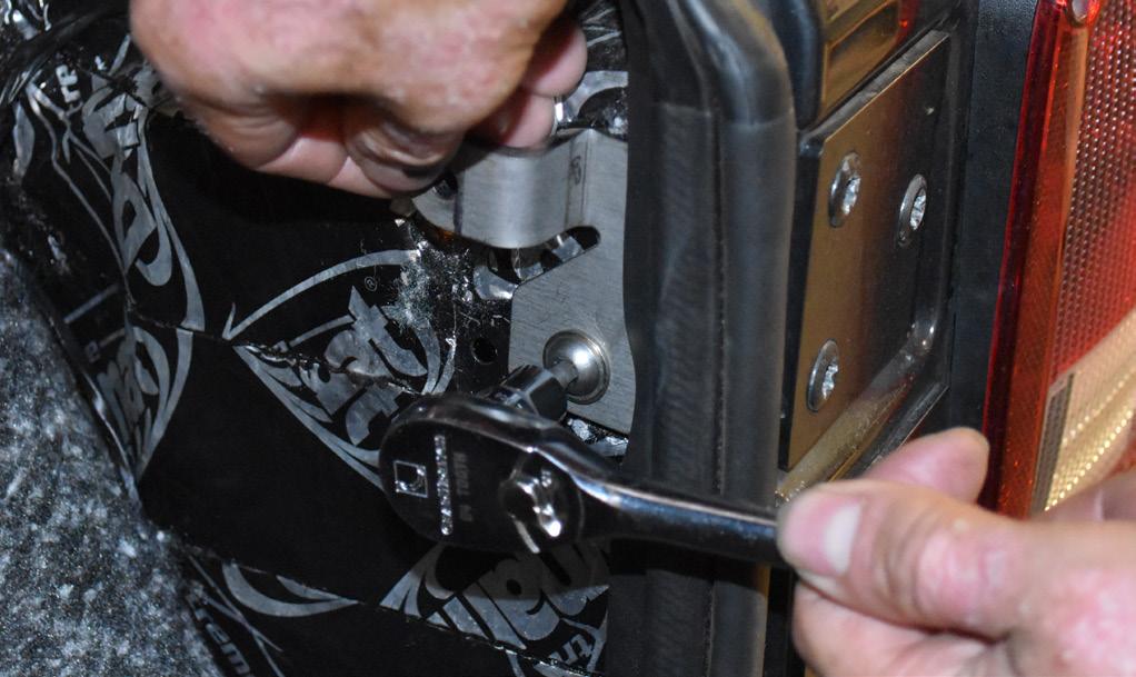 Tighten the screw while holding the bracket perpendicular to the edge of the tailgate opening.