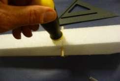 Press the wing dowel down into the slit in the foam down 3/4" from the top of the fuselage. 49.