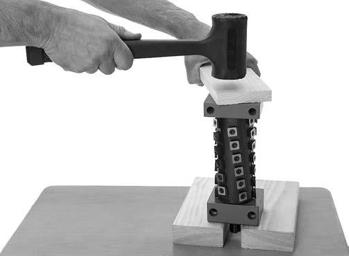 Place the cutterhead assembly on a workbench or flat surface, with the pulley side of the cutterhead shaft facing up, then place the 2x4 blocks under the rear bearing block, as shown in Figure 6.