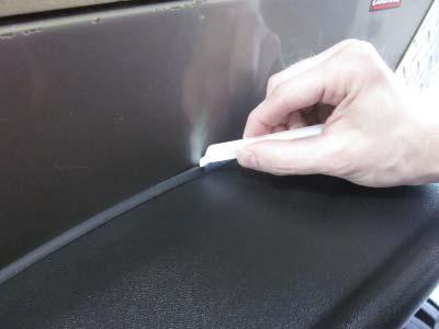 the edge trim to the vehicle surface.