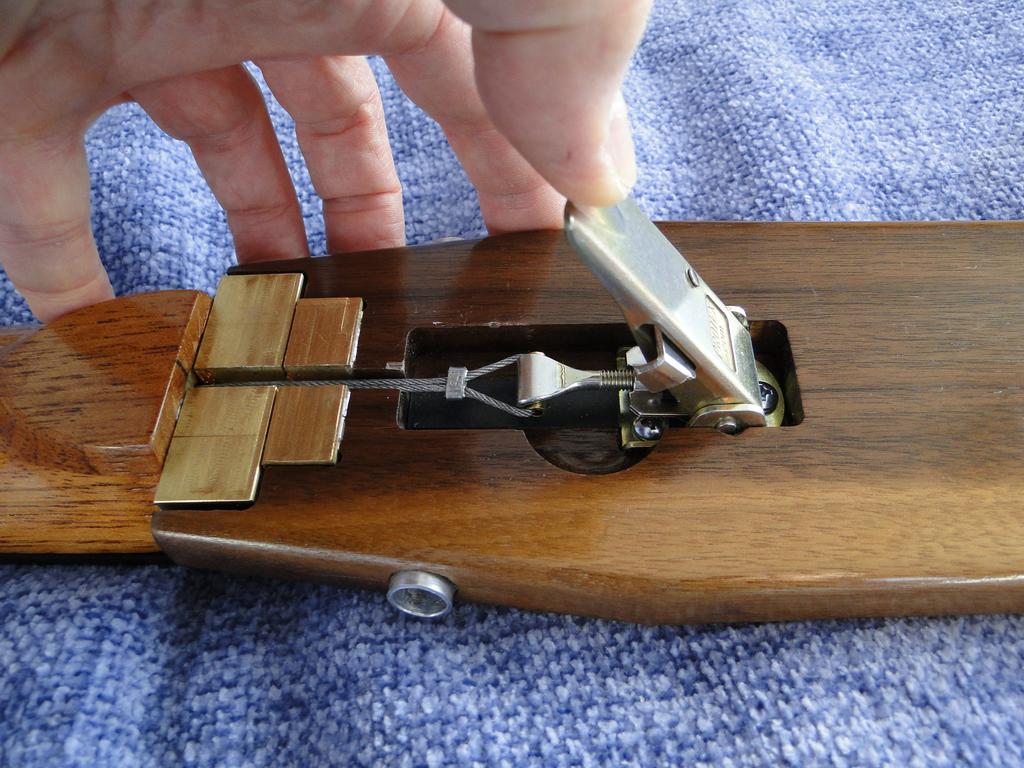 Press the latch on the clamp lever, pull the clamp up and rotate it
