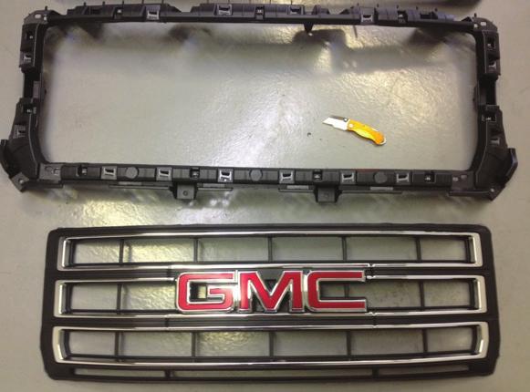 Last, use a Dremel tool or file to take down any sharp edges on the remaining grille shell. step 6 Your grille has been to match the contour of the 2014 GMC 1500 grille shell.