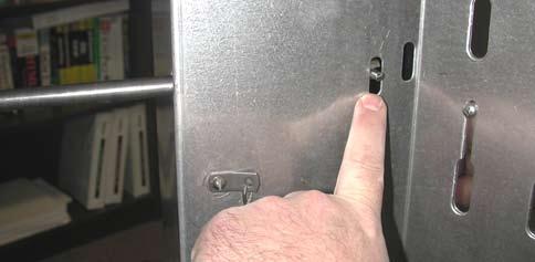 13) Push the spring into one of the two slotted holes on the side of the large hinge piece.