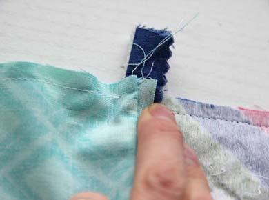 Stop and backstitch ¼ʺ from the tabs at the ends of the zipper.